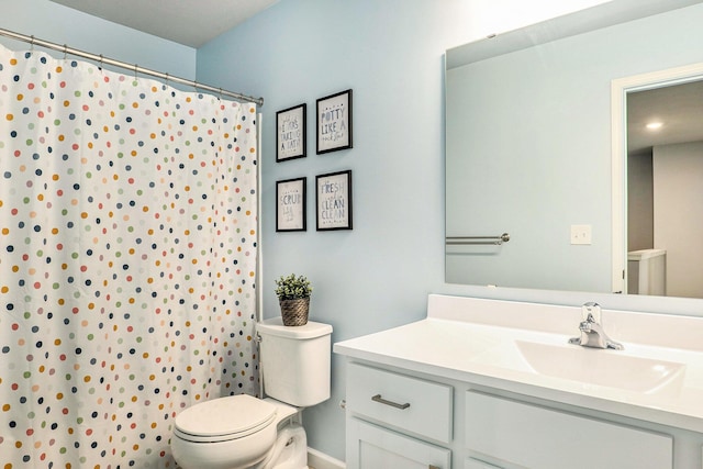 bathroom featuring toilet, vanity, a shower with curtain, and baseboards