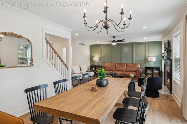 9405 Northern Ave, Plymouth, MI 48170 - dining room with a chandelier, healthy amount of natural light, stairs, a glass covered fireplace, and recessed lighting
