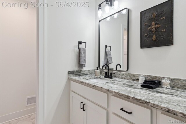 9405 Northern Ave, Plymouth, MI 48170 - bathroom with marble finish floors, vanity, and baseboards