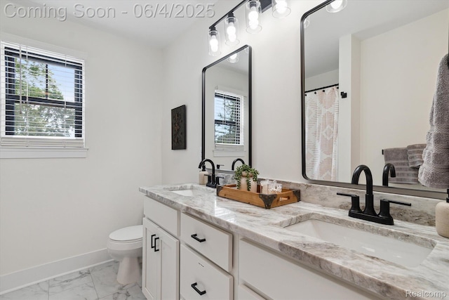 9405 Northern Ave, Plymouth, MI 48170 - bathroom with plenty of natural light, double vanity, toilet, and marble look tiles