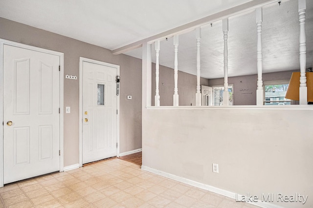 unfurnished room featuring tile patterned floors and baseboards