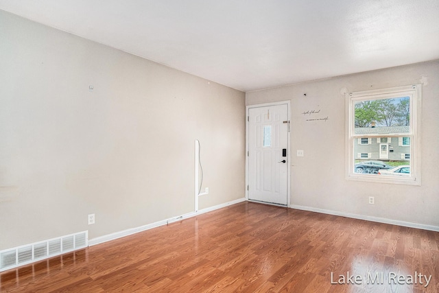 entrance foyer featuring wood finished floors and baseboards