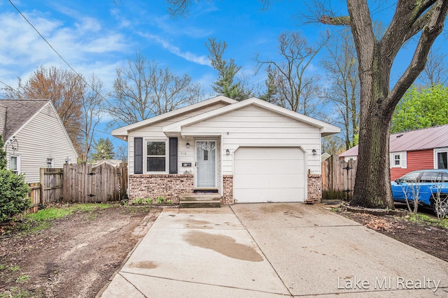 view of front facade with brick siding, fence, and driveway