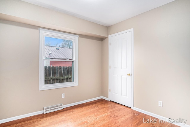 unfurnished bedroom featuring light wood-style floors and baseboards