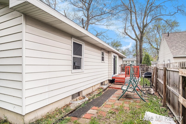 view of home's exterior featuring a wooden deck and a fenced backyard