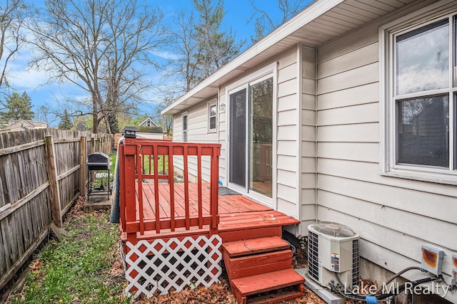 wooden terrace featuring fence and central AC unit