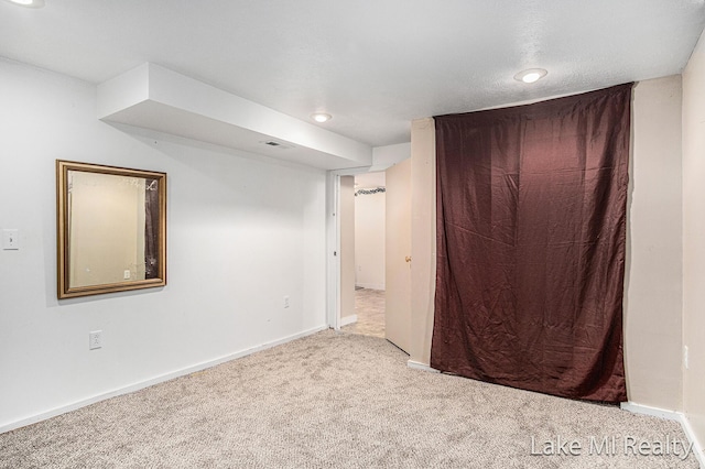 unfurnished room featuring carpet floors, baseboards, and recessed lighting