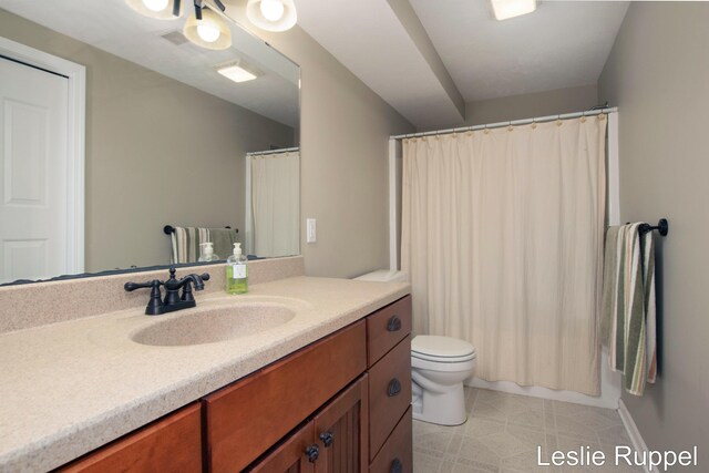 bathroom featuring vanity, toilet, and a shower with shower curtain
