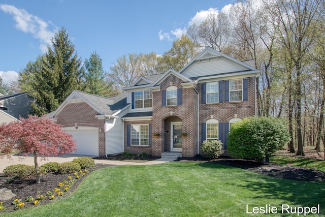 traditional home featuring a garage, brick siding, and a front yard