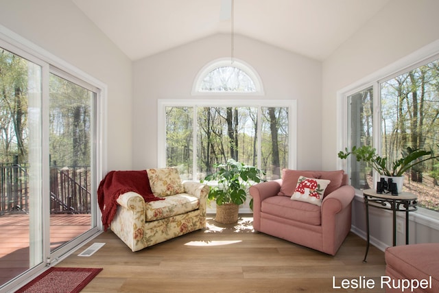 sunroom / solarium featuring vaulted ceiling