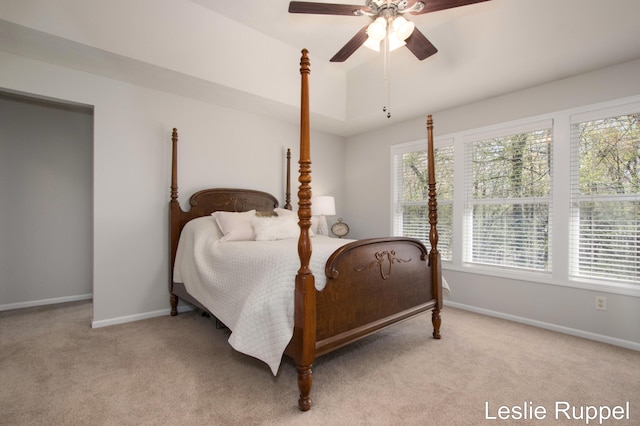 bedroom with light carpet, baseboards, and ceiling fan