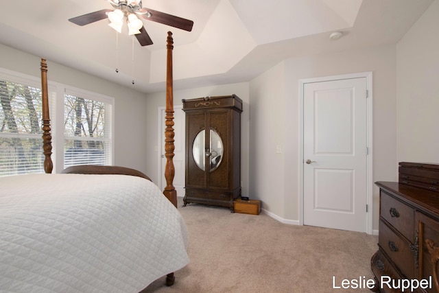 bedroom featuring light carpet, ceiling fan, and baseboards