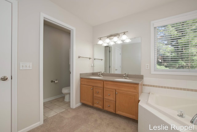 bathroom with a garden tub, double vanity, toilet, and tile patterned flooring