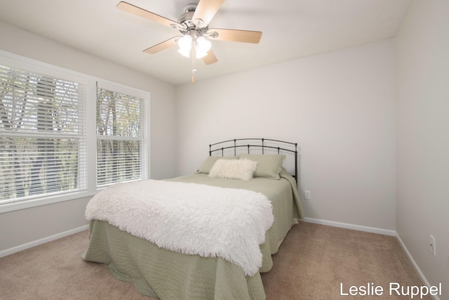 carpeted bedroom with baseboards and ceiling fan