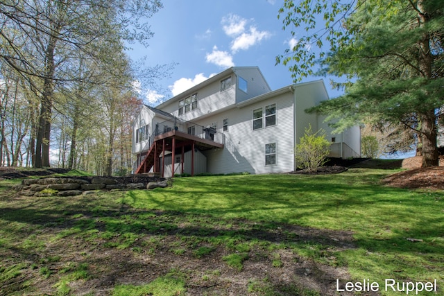back of house with a deck, a yard, and stairs