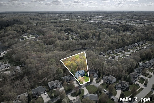 aerial view of residential area featuring a heavily wooded area and property boundaries highlighted