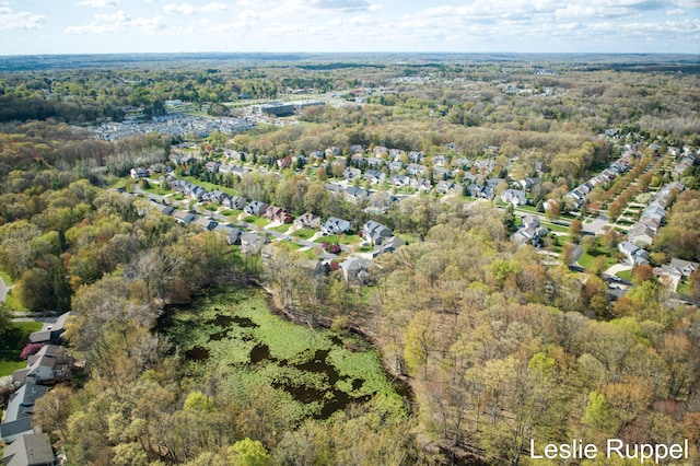 aerial overview of property's location featuring a forest and nearby suburban area