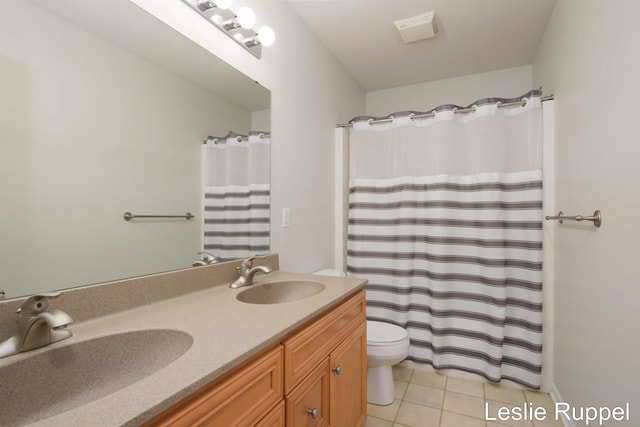 bathroom with tile patterned flooring, toilet, double vanity, and curtained shower