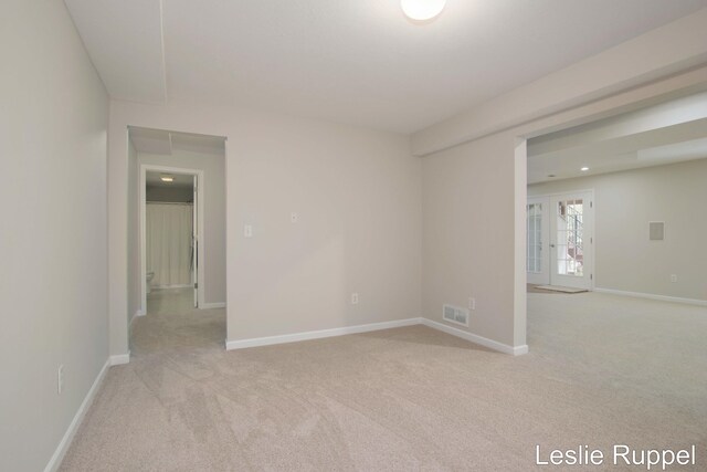 empty room with light carpet and baseboards