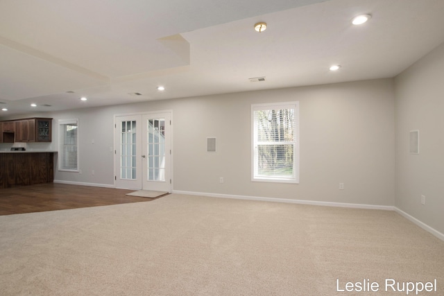unfurnished living room featuring carpet floors, recessed lighting, and baseboards