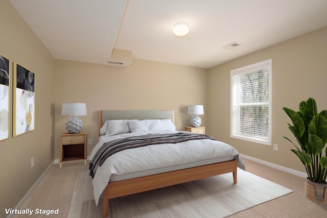 bedroom with light carpet and baseboards