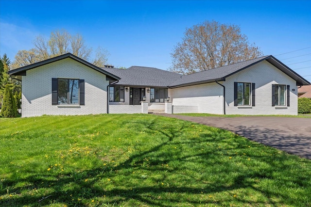 ranch-style house with brick siding and a front lawn