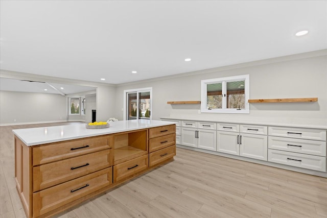 kitchen featuring open shelves, light wood-style floors, healthy amount of natural light, light countertops, and recessed lighting