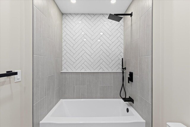 bathroom featuring bathing tub / shower combination and recessed lighting