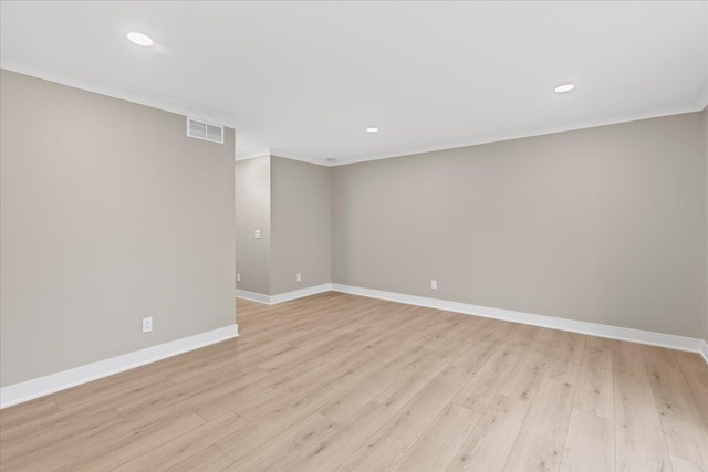 empty room featuring crown molding, baseboards, light wood-style flooring, and recessed lighting