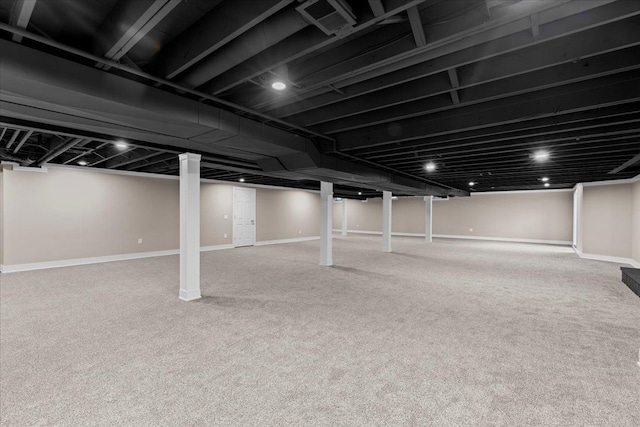 finished below grade area with baseboards and carpet flooring