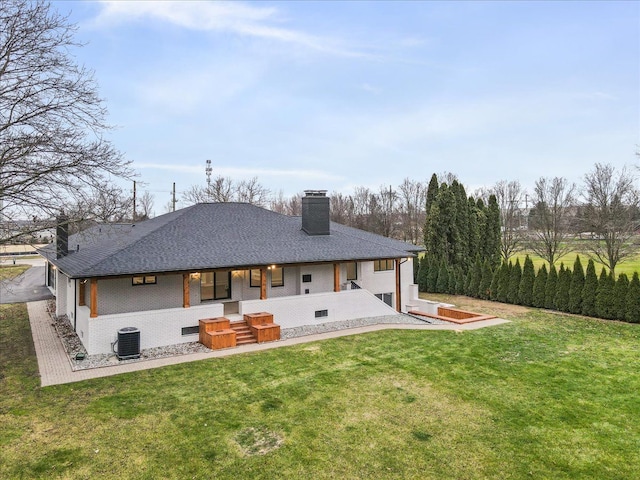 rear view of property featuring a chimney, a lawn, covered porch, and cooling unit