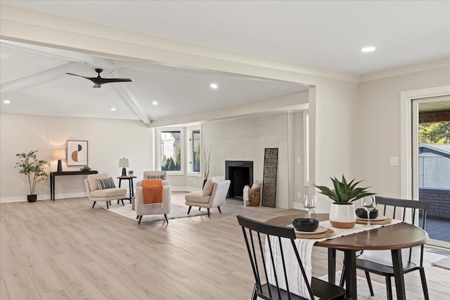 living area with beamed ceiling, light wood-style floors, a fireplace, baseboards, and recessed lighting