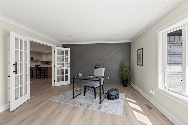 office with french doors, crown molding, light wood-style flooring, and baseboards