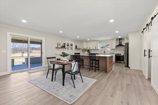 dining area featuring baseboards, ornamental molding, light wood finished floors, and recessed lighting