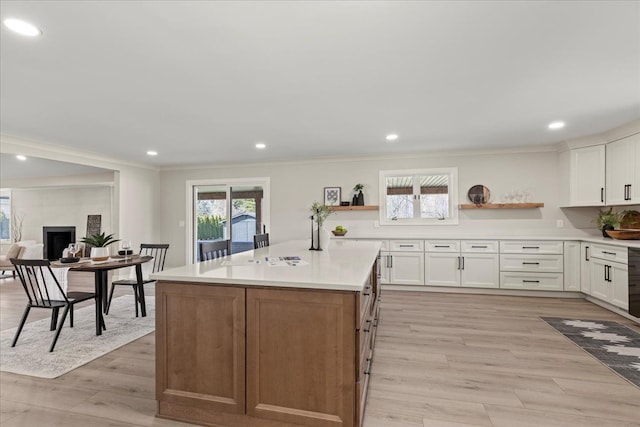kitchen with open shelves, ornamental molding, white cabinets, recessed lighting, and light wood-style flooring