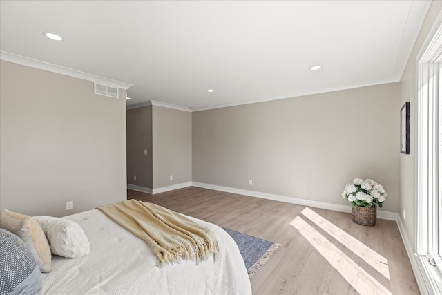 bedroom featuring wood finished floors, crown molding, baseboards, and recessed lighting