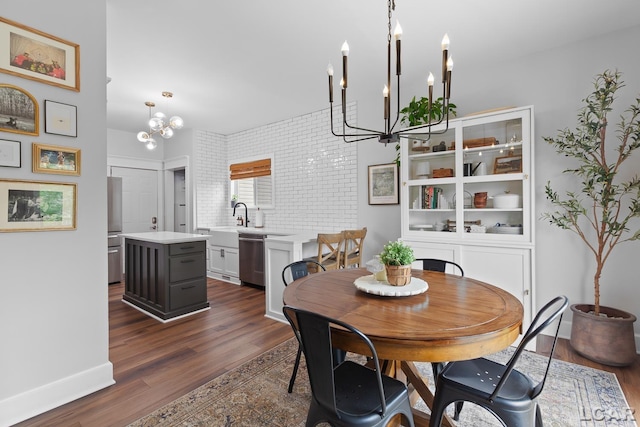 dining room featuring a chandelier, dark wood-style flooring, and baseboards