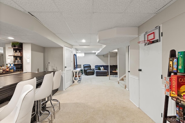 office featuring a paneled ceiling, carpet floors, a bar, and recessed lighting