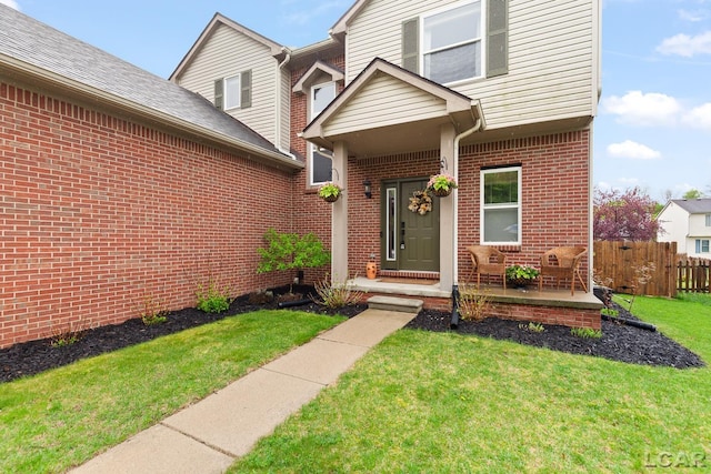 entrance to property featuring brick siding
