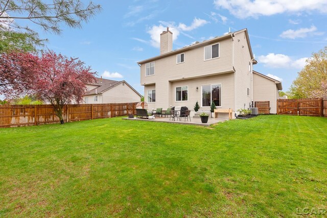 back of property featuring a chimney, a patio area, and cooling unit
