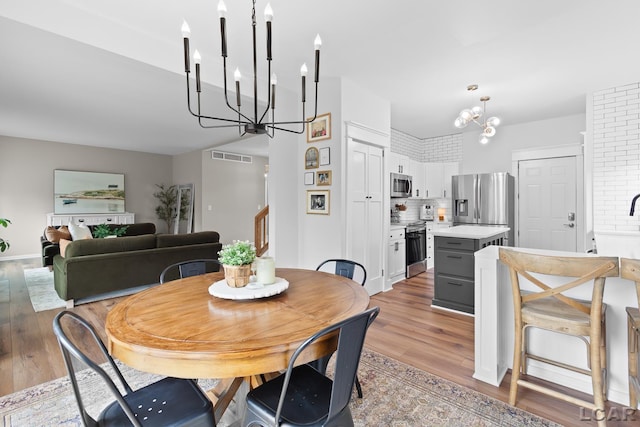dining room featuring a chandelier and light wood finished floors