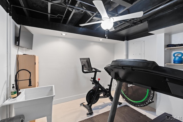 exercise room featuring ceiling fan and a sink