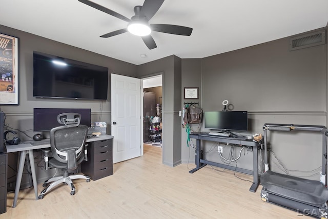 office space with a ceiling fan, light wood finished floors, and baseboards