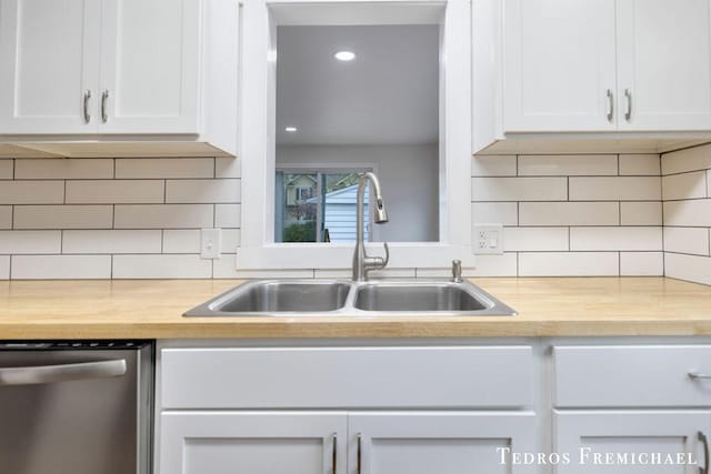 kitchen featuring dishwasher, a sink, butcher block counters, white cabinets, and recessed lighting