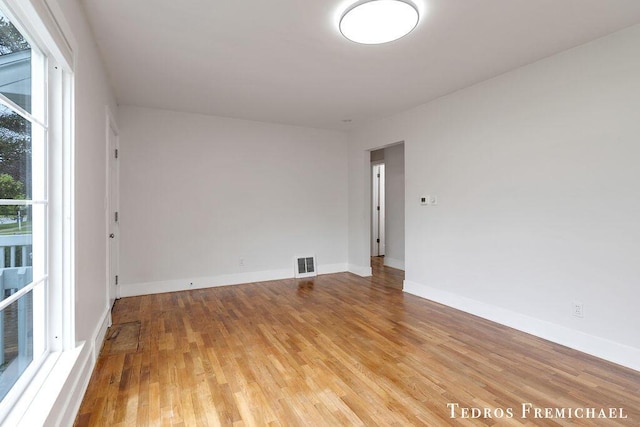 unfurnished room featuring light wood-type flooring and baseboards