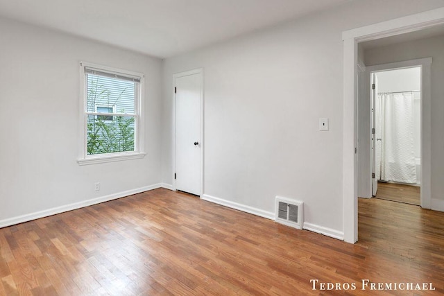 unfurnished bedroom featuring wood finished floors and baseboards