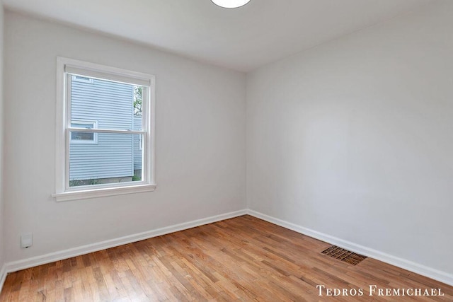spare room with light wood-style flooring and baseboards