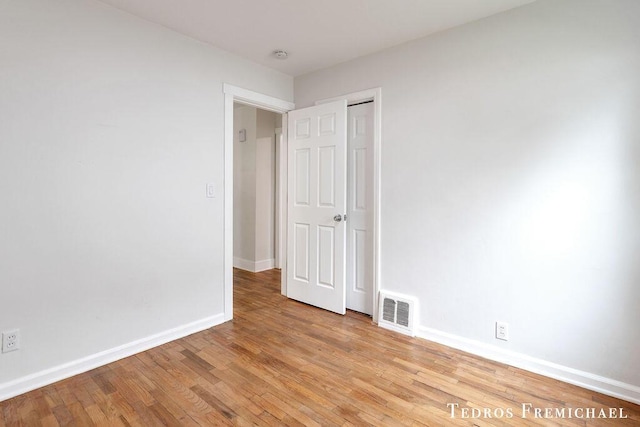unfurnished bedroom with light wood-style flooring and baseboards