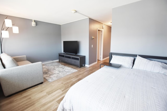bedroom with wood finished floors and baseboards