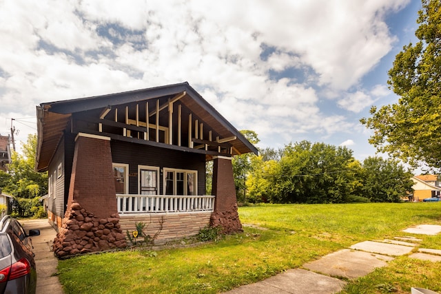 551 Algonquin St, Detroit, MI 48215 - view of home's exterior featuring a lawn, a porch, and brick siding